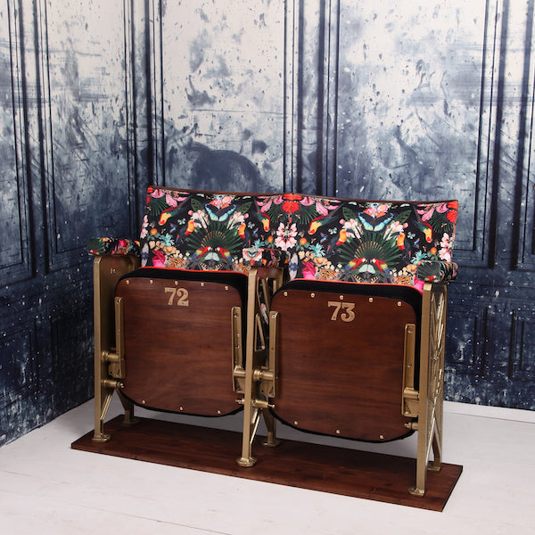 a set of two vintage cinema seat against a marbled blue wallpaper. Cinema seats are upholstered in Paradise Lost velvet with orange velvet piping and black velvet border