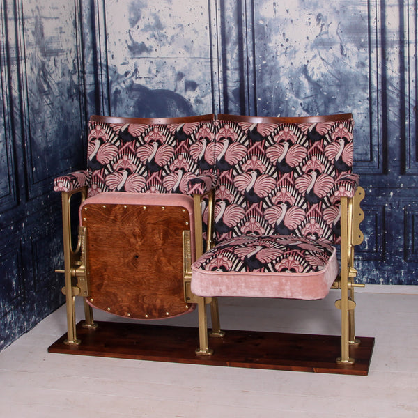 set of two vintage cinema seats upholstered in pink ostrich velvet, sat in front of a blue marbled wall